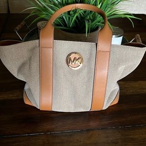 Michael Kors tan with Brown handles. 15x6